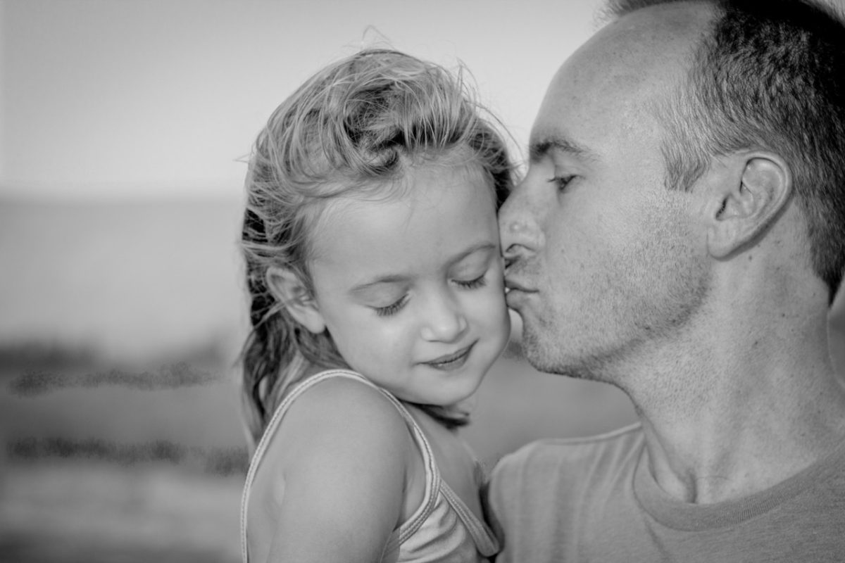 photo of dad kissing little daughter for story daddy's gift by author jenisecook.com