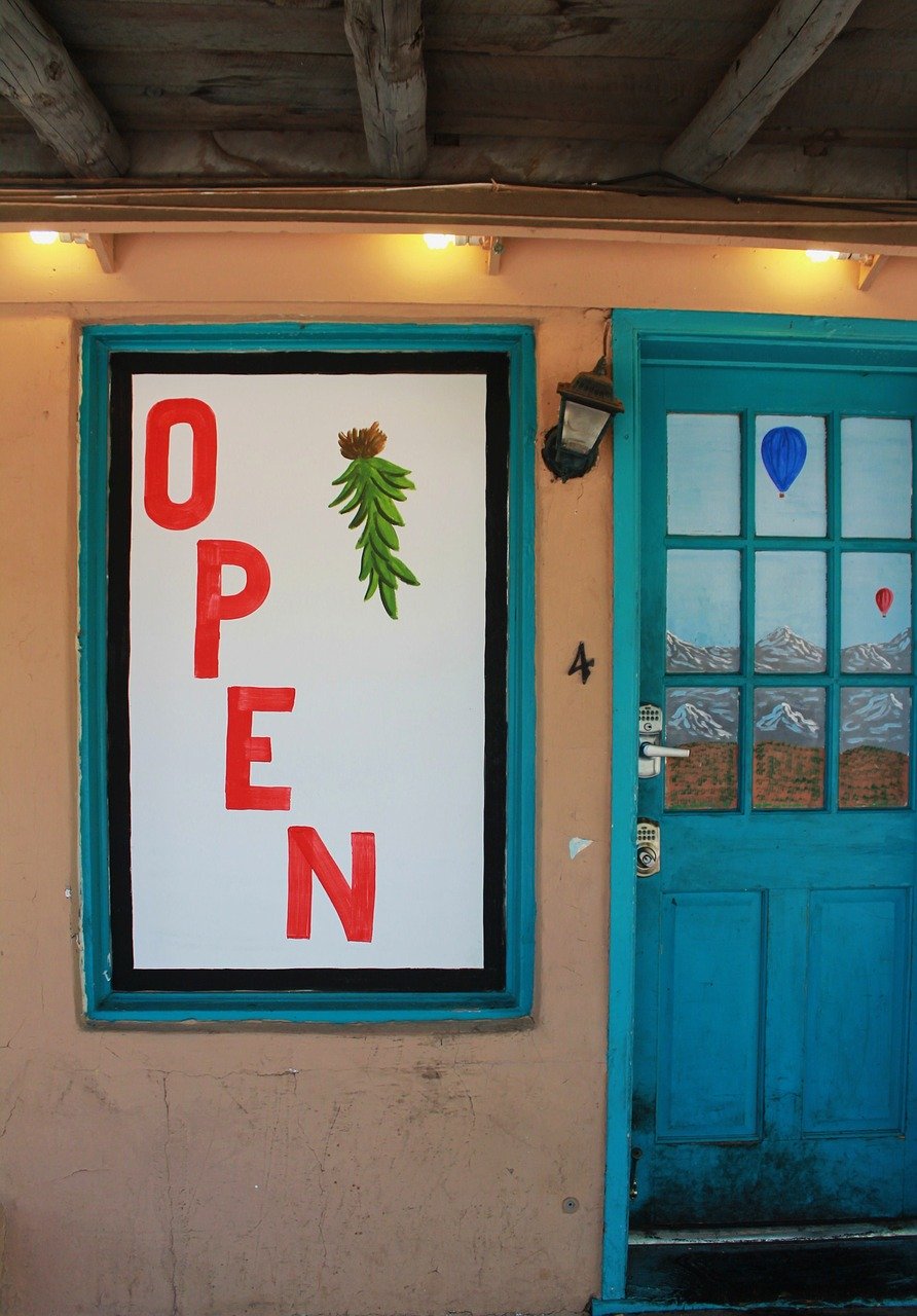 photo of new mexico cafe door open for haiku verse ode to green chilis by author jenisecook.com