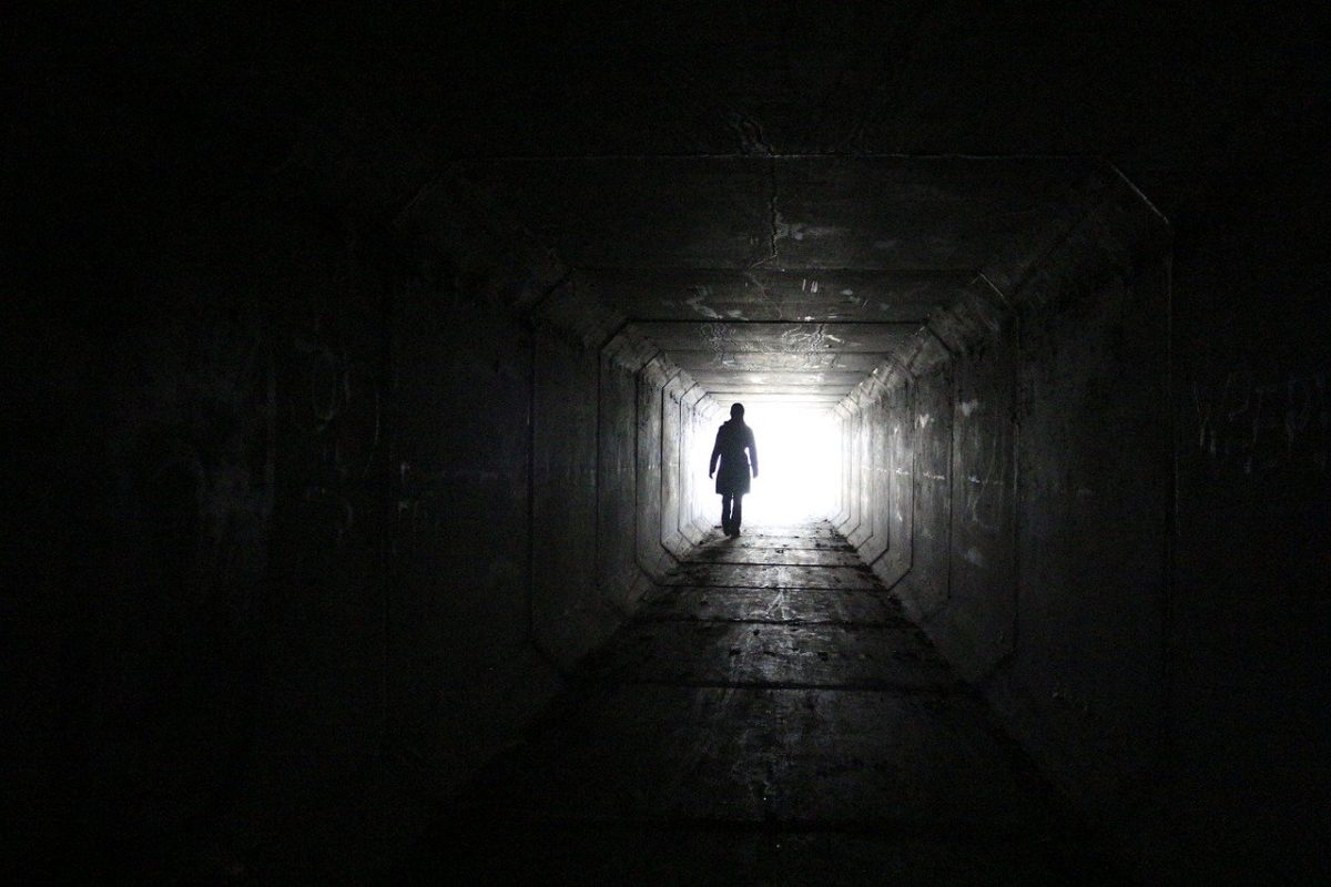 image of man walking down dark tunnel to the light for haiku verse The Tunnel by JeniseCook.com