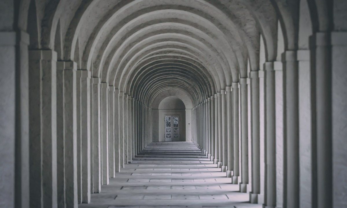 Black and white image of marble columns passageway